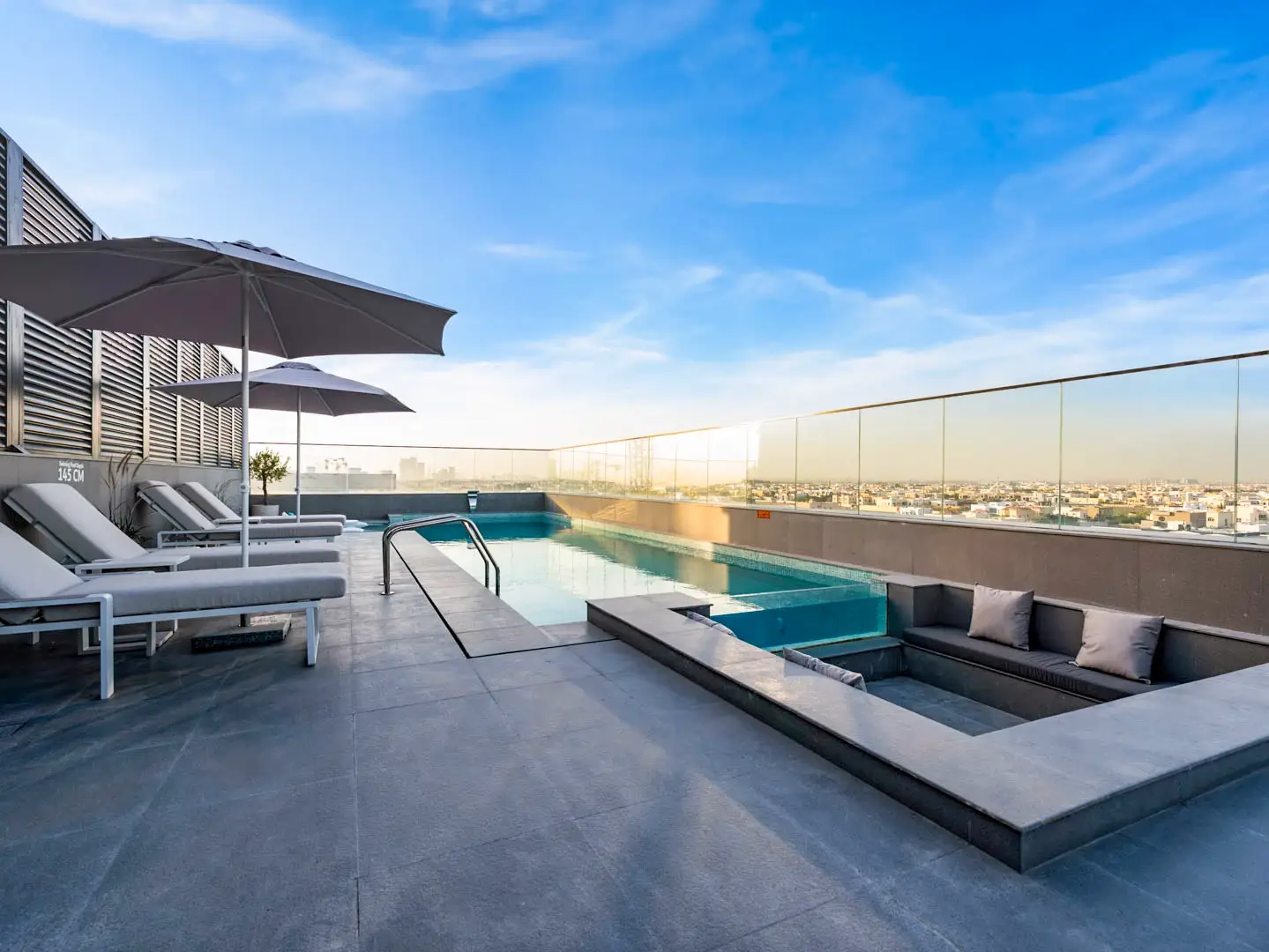 Elegant residential pool surrounded by contemporary architecture and premium amenities.